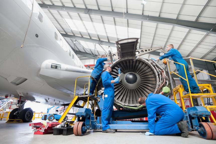 Aerospace technicians working on a jet engine