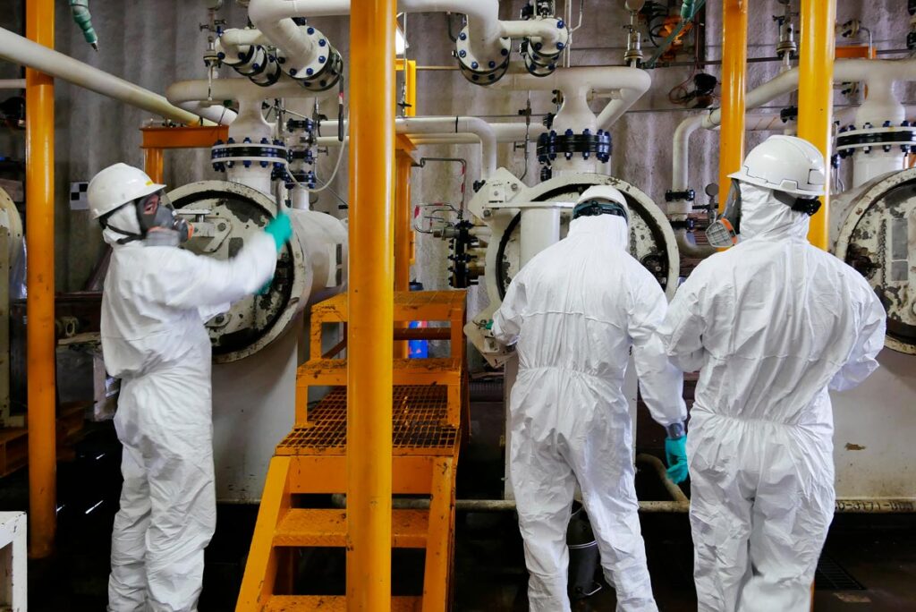 Workers in protective clothing in a power plant