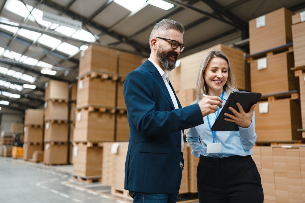 A product manager with a client in a warehouse 