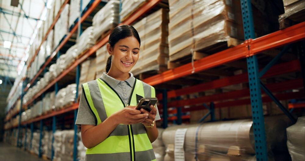 A woman in PPE in a warehouse 