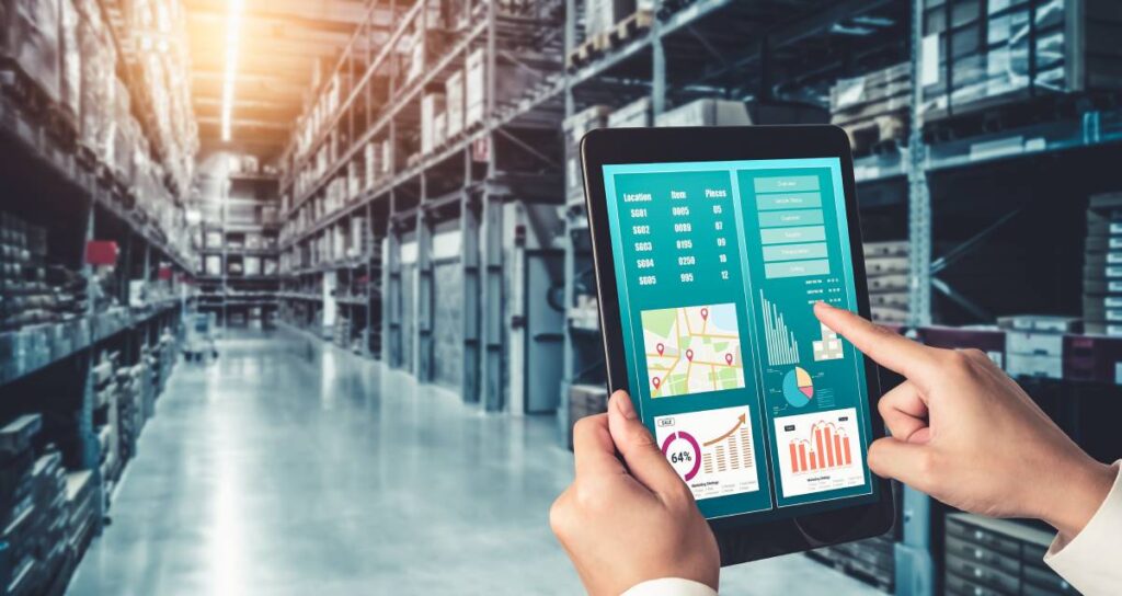 Someone in a warehouse using an ERP system on a tablet.