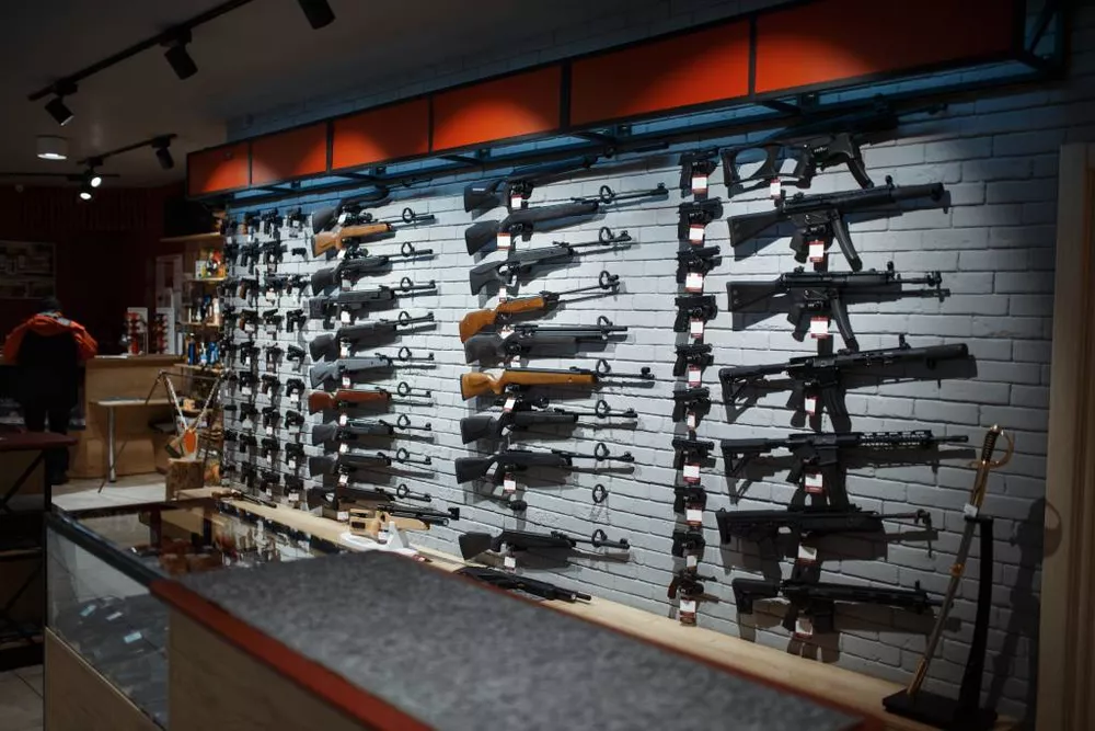 A wall of long guns in a gun store.