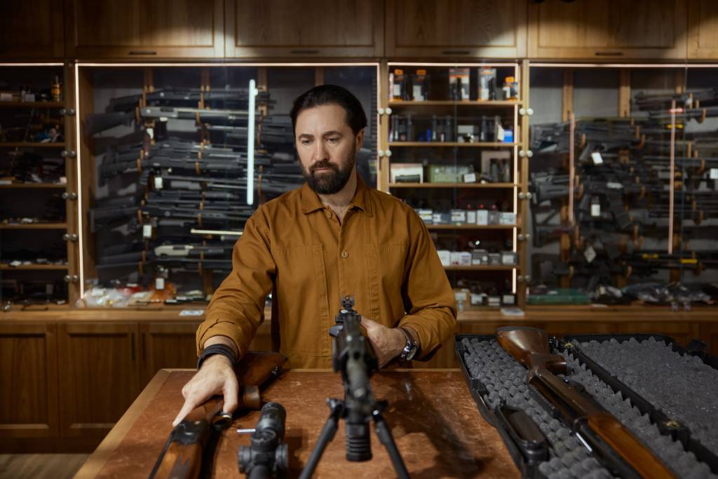 A gun dealer displaying a machine gun.