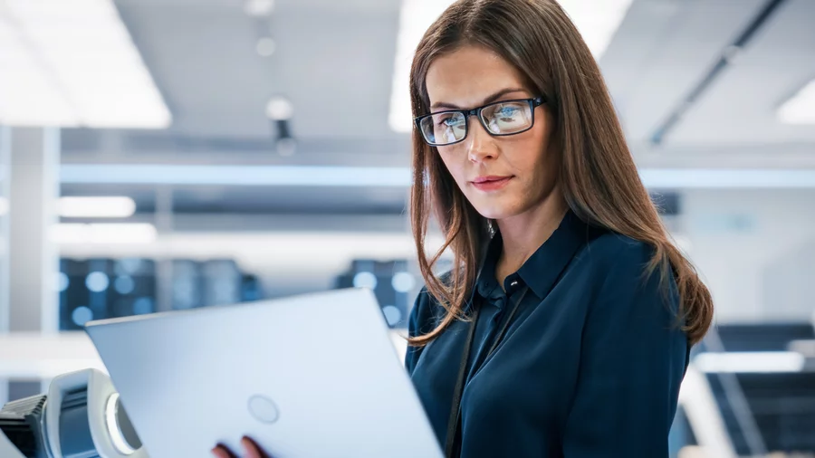 A woman looking at a laptop.