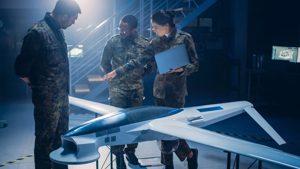 Aerospace engineers looking at a military drone.